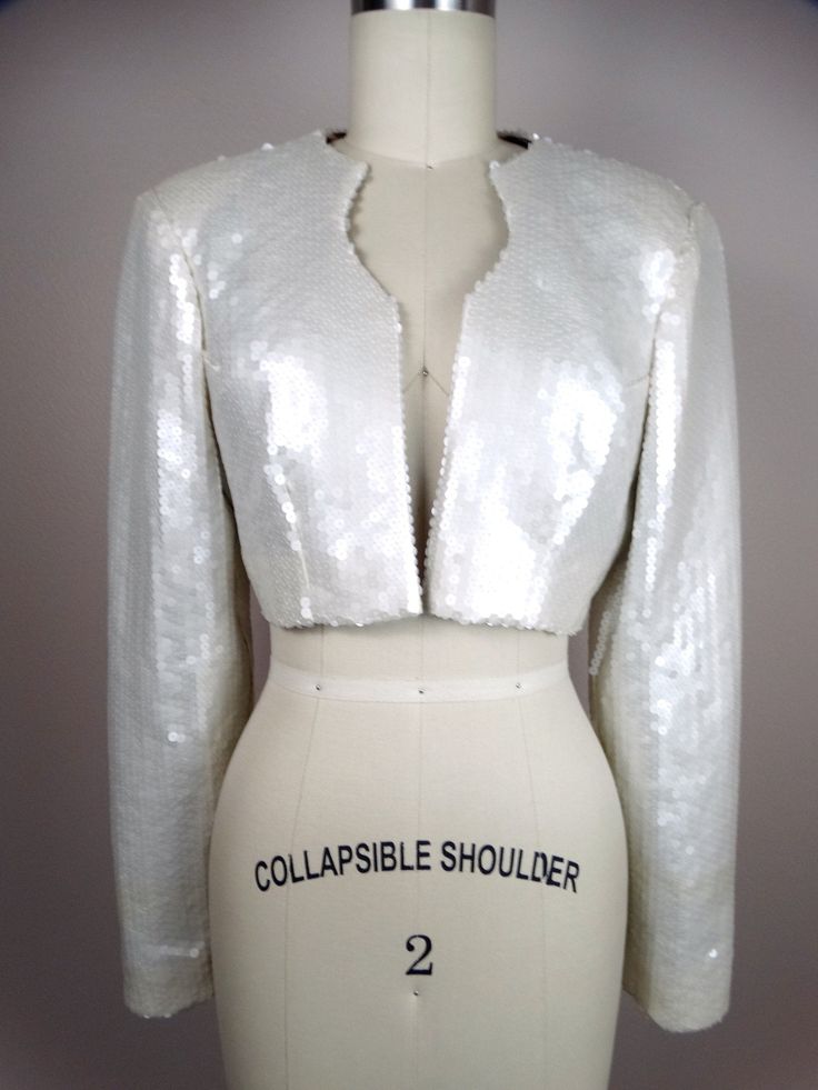 "This is a gorgeous couture vintage bolero jacket fully embellished with pearlescent ivory sequins. It's in perfect condition! Very well made! There are no closures, so measurements are taken with the front brought together. Bust - 36/38\" Shoulders - 16\" Sleeves - 24\" Length - 14\" Tag Size - 8 All of my items come from a smoke-free and pet-free home. If you have any questions, please don't hesitate to ask!" Embellished Fitted Party Outerwear, Fitted Embellished Outerwear For Party, Fitted Embellished Party Outerwear, Fitted Hand Embellished Festive Outerwear, Elegant Fitted Hand-embellished Outerwear, Elegant Fitted Hand Embellished Outerwear, Fitted Long Sleeve Cropped Jacket For Evening, Fitted Cropped Jacket With Long Sleeves For Evening, Fall Wedding Outerwear With Sequins