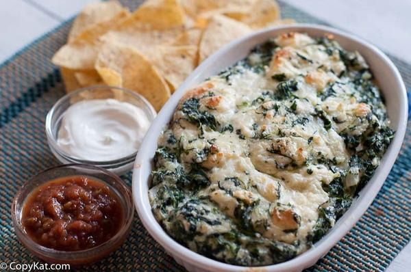 spinach dip with tortilla chips on the side