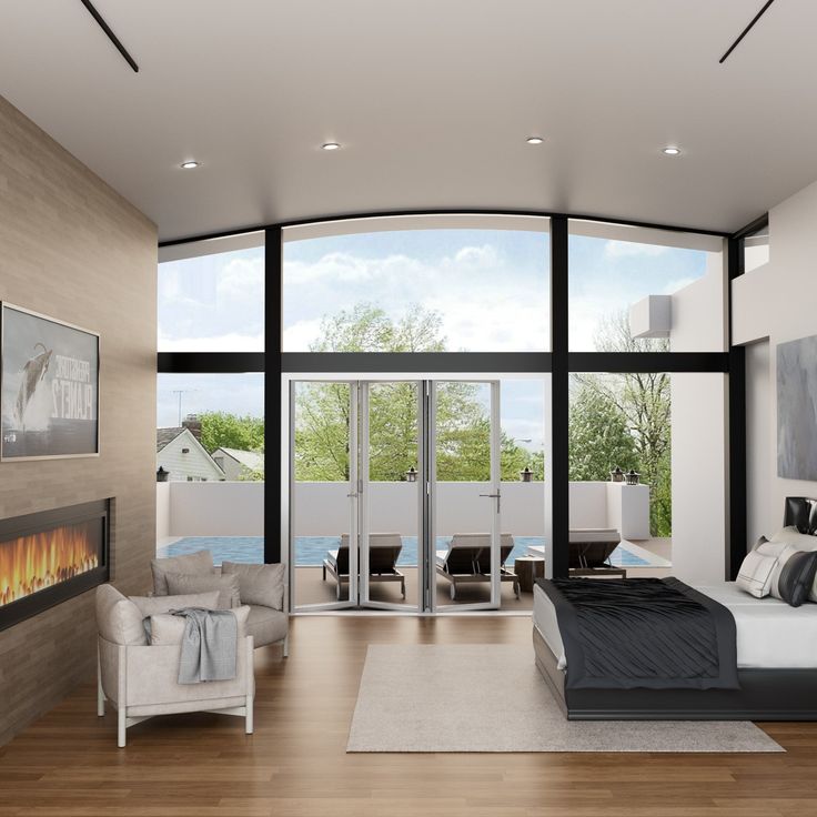 a modern bedroom with large windows and a fireplace