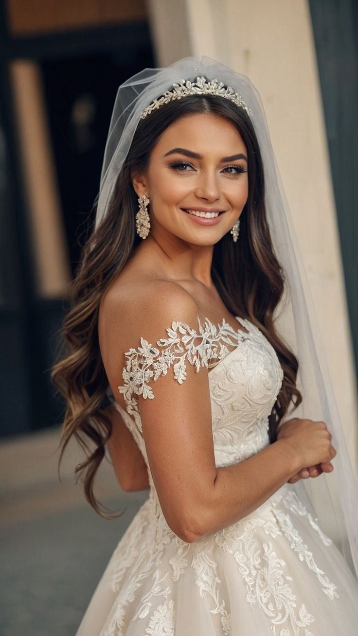 a woman in a wedding dress and veil posing for the camera with her hand on her hip