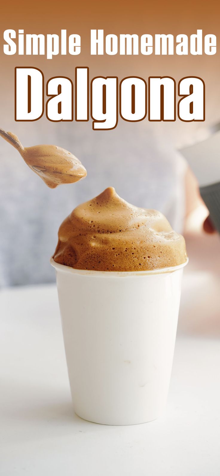 a white cup filled with coffee sitting on top of a table