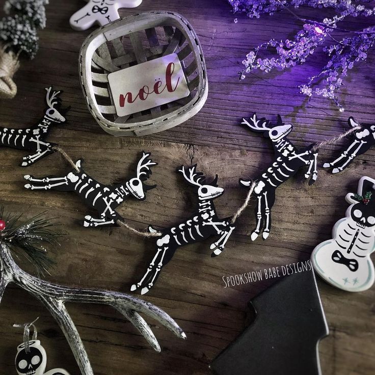 some skeleton decorations on a table with purple flowers