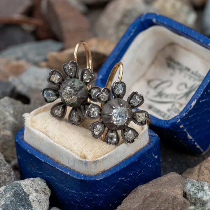 These exquisite circa mid-Victorian era sterling silver earrings feature a floral design, each centered with a bead set, old mine cut diamond. Each petal is bead set with one (1) antique cut diamond. The earrings measure 19.9mm long, including the gold lever style backs, by 15.0mm wide. We left the earrings unpolished to keep the natural rich dark patina on the finish. Antique Rose Cut Diamonds Jewelry For Vintage Events, Vintage Rose Cut Diamond Earrings, Victorian Yellow Gold Earrings With Single Cut Diamonds, Antique Pierced Diamond Jewelry, Antique Rose Cut Diamond Drop Earrings, Victorian Yellow Gold Diamond Earrings With Single Cut Diamonds, Antique Diamond Earrings With Single Cut Diamonds, Antique Single Cut Diamond Earrings As Gift, Antique Diamond Earrings With Single Cut Diamonds As Gift