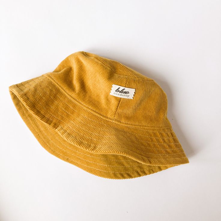 "The perfect bucket sun hat for women,men, babies and kids! Made from 100% cotton mustard yellow corduroy makes this hat very comfortable to wear. I made this hat with a day of adventure in mind, somewhere sunny and wild! This hat is made from a mustard yellow 100% cotton corduroy fabric. Inside liner is white cotton. Brim measures approx. 2.5\" wide. Crown measures approx. 3.5\" deep. Available in sizes: 0-3 mos. - 12\" to 14\" head circumference 3-6 mos. - 14\" to 16\" head circumference 6-12 Cheap Yellow Casual Sun Hat, Yellow Cotton Summer Bucket Hat, Yellow Summer Cotton Bucket Hat, Casual Yellow Cotton Bucket Hat, Yellow Cotton Sun Hat, One Size Fits Most, Yellow Adjustable Cotton Bucket Hat, Yellow Cotton Sun Hat, Yellow Cotton Bucket Hat With Short Brim, Yellow Cotton Casual Sun Hat