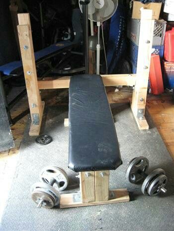 a bench and dumbbells in a garage