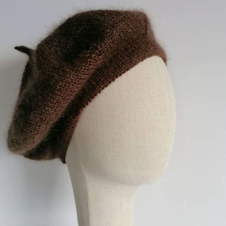 a white mannequin head with a brown hat on it's headband