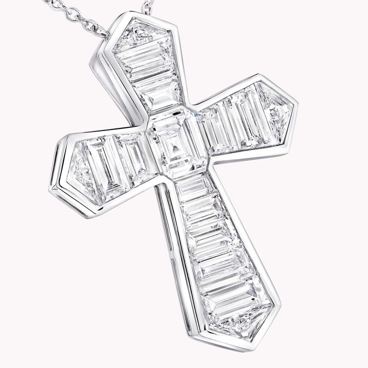 A contemporary interpretation of a classic motif, this Cross pendant in 18 carat white gold is beautifully crafted to showcase the sleek beauty of baguette cut diamonds. Custom cut to fit the design, the diamonds are individually handset by our master artisans to taper in size as they radiate outwards. An elegant Classic Graff cross motif baguette cut diamond pendant with a total weight of approximately 3.06 carats. Luxury Silver Baguette Cut Diamond Necklace, Luxury Silver Baguette-cut Diamond Necklace, White Baguette Cut Diamond Necklace, Diamond White Platinum Necklace With Baguette Diamonds, Platinum Diamond Necklace With Baguette Diamonds, White Gold Diamond Necklace With Baguette Diamonds In Platinum, Silver Baguette Cut Platinum Diamond Necklace, Silver Platinum Baguette Cut Diamond Necklace, Platinum Diamond White Necklace With Baguette Diamonds