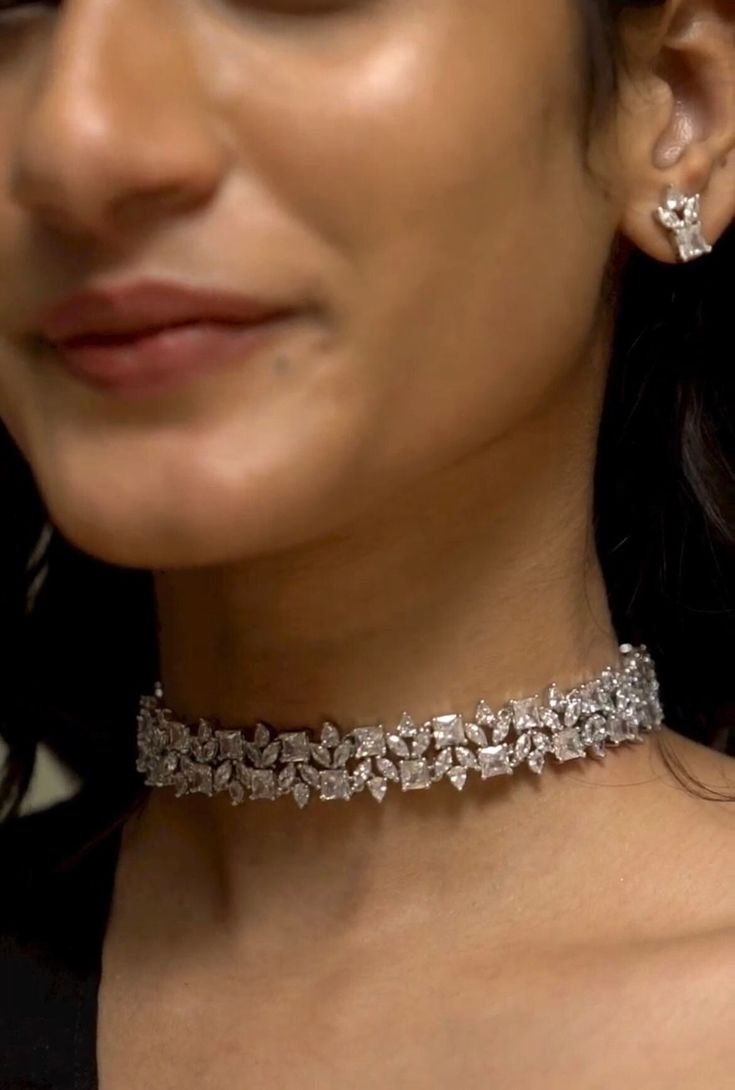 "The American Diamonds / Zirconium choker necklace is designed to grace the neckline elegantly, accentuating the contours of a high neck dress or ensemble. Its sleek and streamlined silhouette hugs the neck with effortless grace, creating a captivating focal point that draws the eye upward. Style this perfect versatile cocktail necklace set with any Indian / Indo Western Attire.   WHAT GOES IN  👉🏻American Diamond / Cubic Zirconia AD Necklace Set with earrings in silver finish.  👉🏻Necklace Le Luxury Diamond Choker Necklace For Women, Luxury Choker For Formal Occasions, Luxury Silver Cutdana Choker, Luxury Diamond Choker Necklace As Gift, Luxury Silver Choker For Celebrations, Luxury Silver Choker For Party, Silver Necklace Chocker, Diamond Necklace Set Simple Choker, Luxury Cutdana Choker For Women