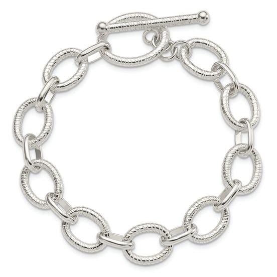 Sterling silver polished and textured fancy link chain bracelet with toggle clasp. Measures approximately 7 1/2"L x 1/2"W. Elegant Metal Toggle Necklace With Oval Link, Elegant Sterling Silver Bracelet With Oval Link Toggle Clasp, Elegant Oval Link Chain Bracelet With Toggle Clasp, Elegant Silver Charm Bracelet With Rectangular Links, Elegant Chain Bracelet With Toggle Clasp And Rectangular Links, Elegant Silver Chain Link Charm Bracelet, Elegant Silver Toggle Necklace With Oval Link, Silver Formal Chain Link Charm Bracelet, Formal Metal Toggle Necklace With Oval Links