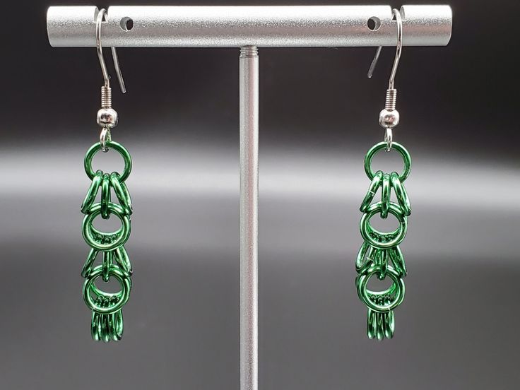 The Shaggy Loops weave makes particularly cute earrings! They're a perfect way to add a touch of fun to any outfit. Made of high grade anodized aluminum, with surgical stainless steel earrings, these are a lightweight set of earrings that will not weigh your ears down (saving you from that itching sensation heavier sets can cause!). Their deep evergreen shade is perfect for Christmas! The earrings are made of high-grade aluminum, with stainless steel posts. For cleaning, use a soft cloth or brus Green Metal Dangle Hoop Earrings, Green Dangle Metal Hoop Earrings, Green Dangle Hoop Earrings In Metal, Nickel Free Green Metal Earrings, Nickel-free Green Metal Earrings, Green Metal Hoop Earrings As A Gift, Modern Green Metal Earrings, Chain Mail Earrings, Aluminum Earrings