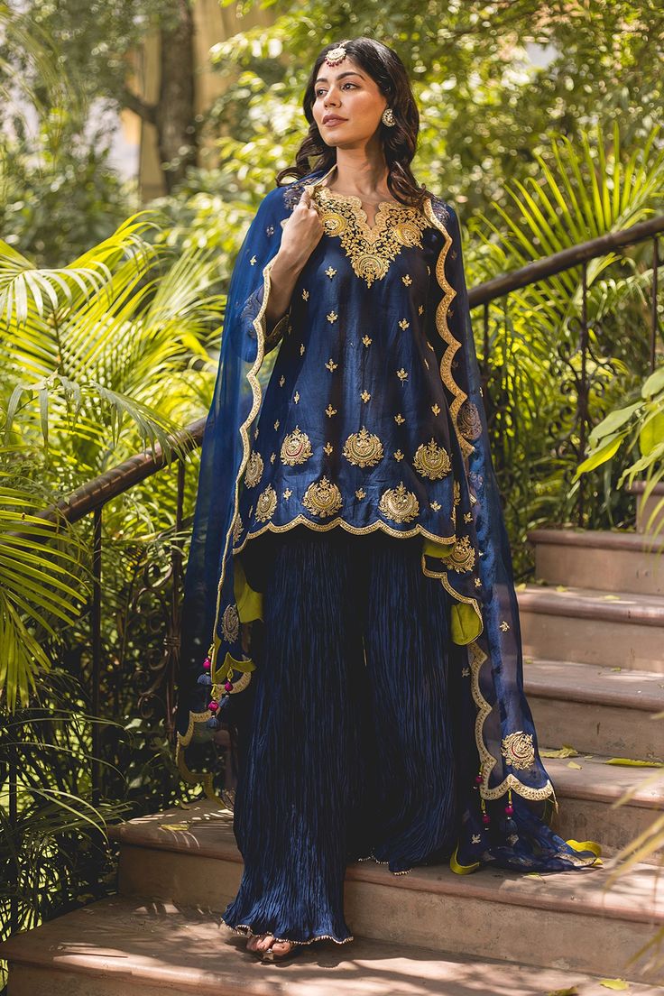 Shop for these amazing collections of Blue Chanderi Embroidery Marori Notched Banarasi Kurta And Sharara Set For Women by Surbhi Shah online at Aza Fashions. Traditional Drape Palazzo Set With Dori Work For Eid, Blue Chinon Kurta With Sheer Dupatta, Eid Palazzo Set With Dori Work In Traditional Drape, Designer Sharara With Dori Work For Diwali, Designer Dori Work Sharara For Diwali, Blue Sharara With Gota Work In Chinon, Blue Chinon Sharara With Cutdana Detail, Blue Traditional Wear With Sheer Dupatta In Chinon, Diwali Palazzo Set With Dori Work In Traditional Drape