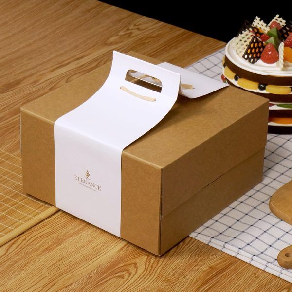 an open box sitting on top of a wooden table next to a plate and fork