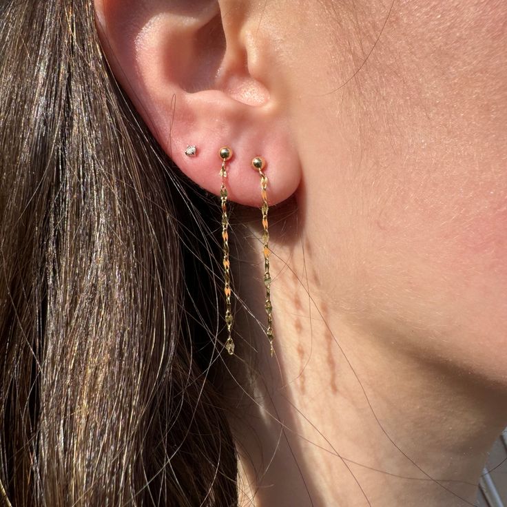 We love these earrings because they make a simple statement. These diamond cut, tinsel like earrings look effortless on their own or meticulously styled together with another pair of your favorites. Sold as a pair. 14k yellow gold chain drops about 1” This item ships quick! 14k Gold Threader Earrings, 14k Gold Filled Threader Earrings, Fine Jewelry Drop Earrings With Adjustable Chain, Dangle Linear Earrings With Cable Chain As Gift, Fine Jewelry Dangle Earrings With Delicate Chain, 14k Gold Filled Yellow Gold Threader Earrings, Gift Linear Dangle Earrings With Cable Chain, Delicate Chain Dangle Earrings, 14k Gold Filled Diamond Cut Earrings For Gift