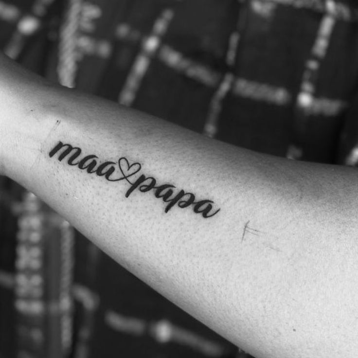 a person with a tattoo on their arm that reads macappa and has a heart in the middle