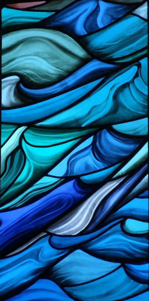 a stained glass window with blue and green waves