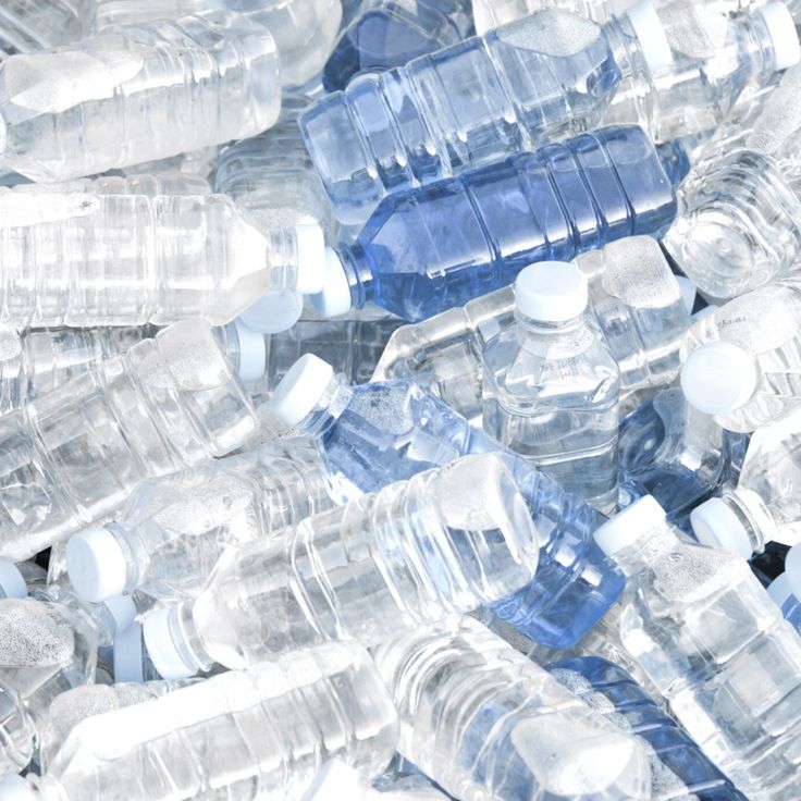 many plastic water bottles are stacked together