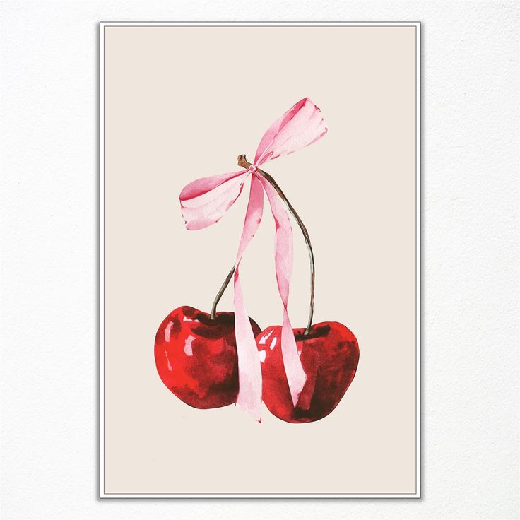 two cherries with pink ribbon tied to them on a beige background, against a white wall