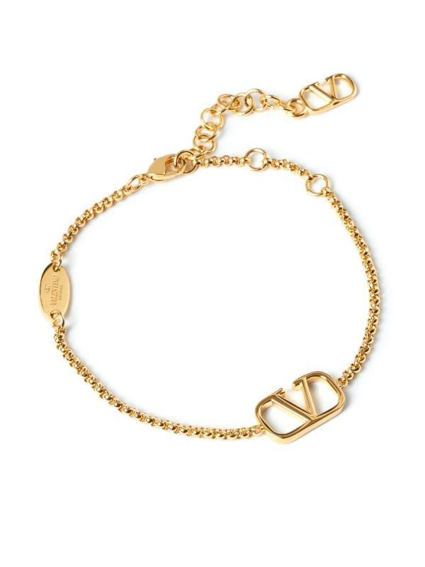 Valentino Garavani VLogo Signature Chain Bracelet - Farfetch Gold-tone Bracelet With Logo Charm As Gift, Luxury Gold-tone Tarnish Resistant Charm Bracelet, Gold-tone Plated Jewelry With Logo Plaque, Yellow Gold Metal Jewelry With Gold-tone Logo, Elegant Gold Jewelry With Logo Charm, Formal Yellow Gold Jewelry With Logo Charm, Luxury Chain Bracelet With Logo Charm, Luxury Chain Charm Bracelet For Formal Occasions, Luxury Gold-tone Jewelry With Logo Charm