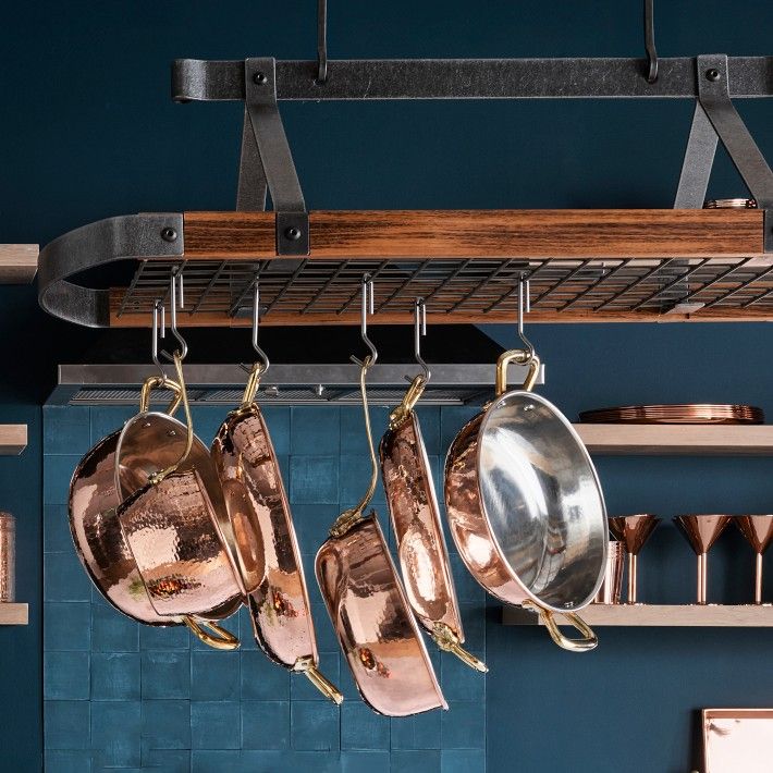 pots and pans hanging from a rack in a kitchen