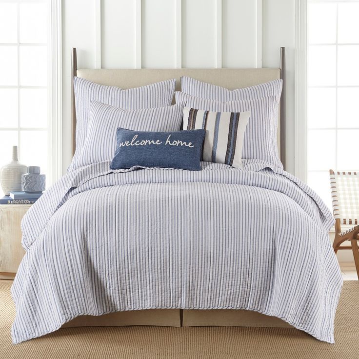 a blue and white striped comforter set with pillows