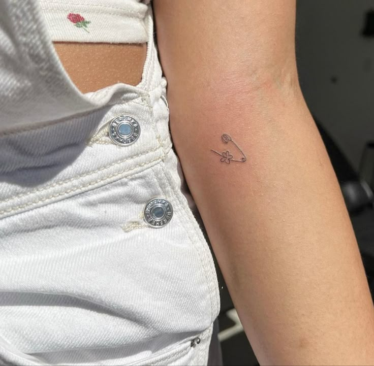 a woman with a small tattoo on her arm