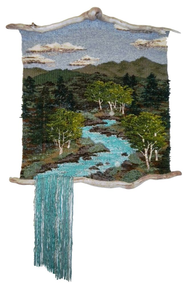 a tapestry hanging on the wall with a river running through it