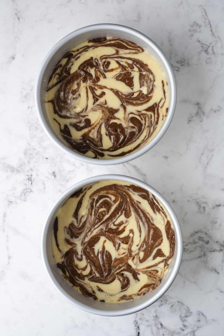 two bowls filled with brown and white swirled desserts