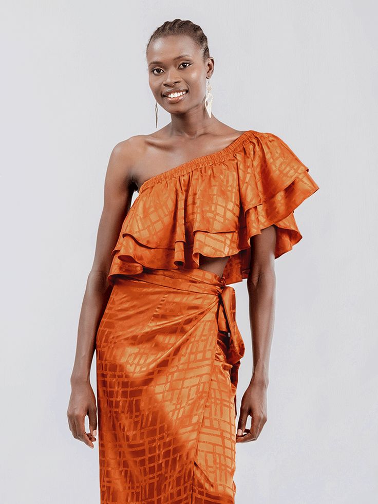 Elevate your resort style with our stunning ruffled crop top, featuring elasticized shoulders and waist, for a comfortable and flattering fit. Handcrafted in our small atelier in Dakar, Senegal, this top is perfect for sunny getaways and beachside adventures, adding a touch of elegance to your vacation wardrobe. Complete the look with our matching Seur Skirt for effortless coordination. Ruffled crop top Elasticized shoulders and waist Versatile top: convertible to one-shoulder and off-the-should Off-shoulder Ruffle Crop Top For Brunch, Chic Ruffled Crop Top For The Beach, Chic Ruffled Crop Top For Vacation, Chic One Shoulder Beach Crop Top, Chic One Shoulder Crop Top For Beach, Small Atelier, Ruffled Crop Top, Dakar Senegal, Vacation Wardrobe