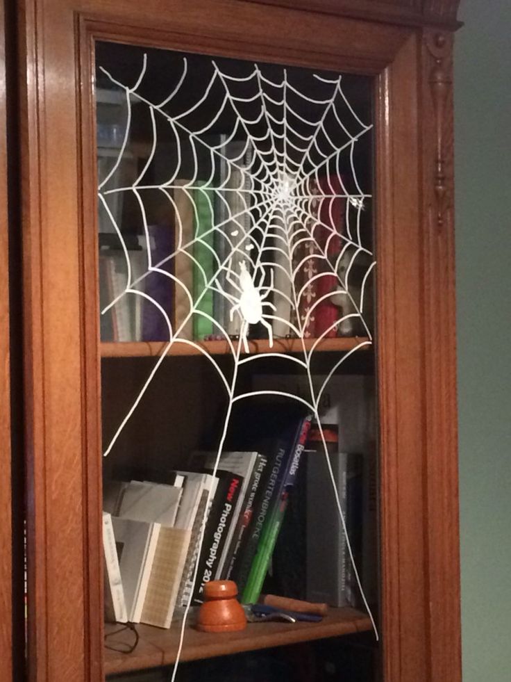 a book shelf with a spider web on it