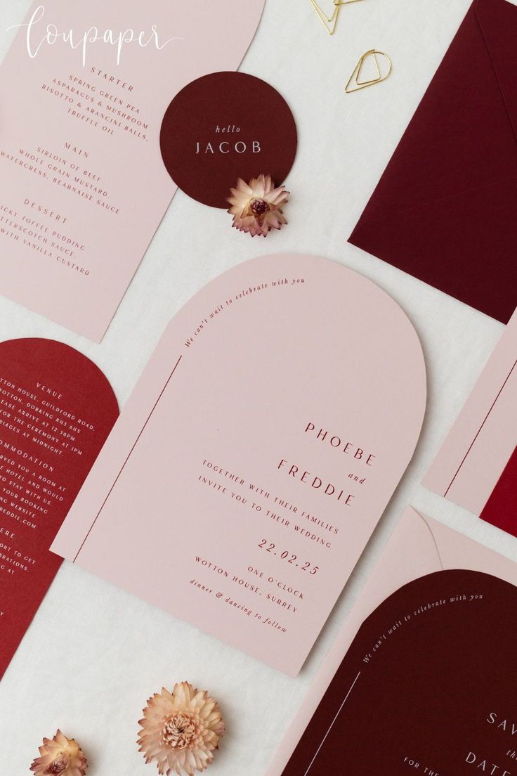 the wedding stationery is laid out on top of each other