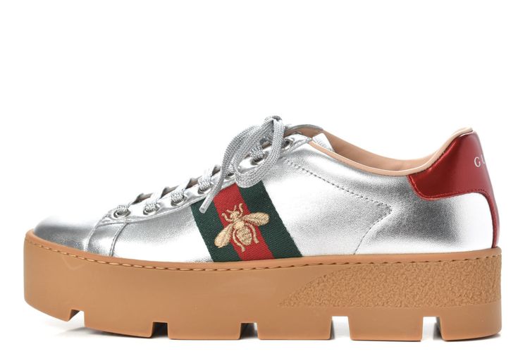 Gucci Women's Ace Silver Embroidered Platform Sneaker N5386 Size 39.5 / 9.5 US Details The classic Ace sneaker is set on a platform and shows the metallic gold bee against the Gucci Web. Since its debut, the Ace sneaker has become a mainstay of Gucci collections.  The retro design is originally inspired by a Gucci sneaker from the 1970s and is continually reinterpreted and reintroduced into the new eclectic House narrative.  Crafted from silver-tone leather with green and red Web and gold thread Gucci Sneaker, Embroidered Bee, Red Web, Eclectic House, Gucci Sneakers, Gold Bee, Leather Detail, Gold Thread, Platform Sneaker