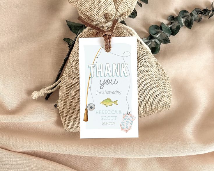 a thank you bag with a fishing themed tag on it and some plants in the background