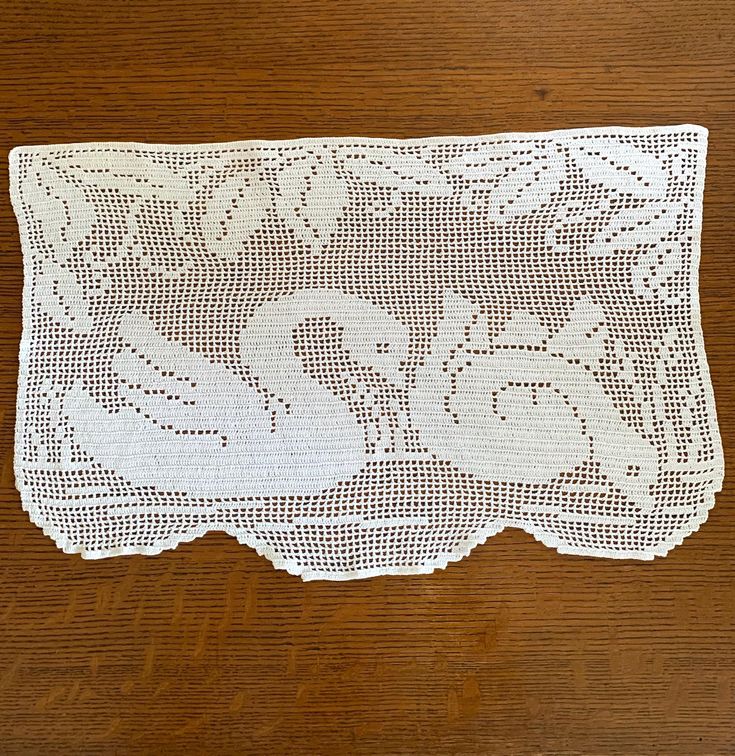 a white doily on top of a wooden table