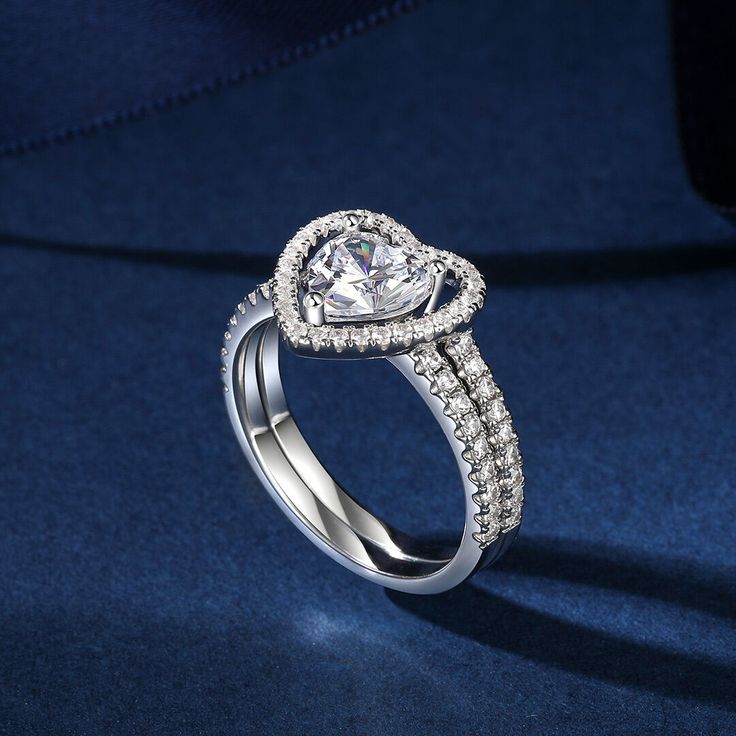 a heart shaped diamond ring on a blue background