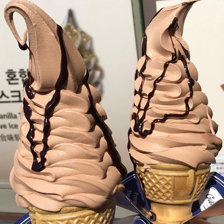 two ice cream cones sitting on top of each other