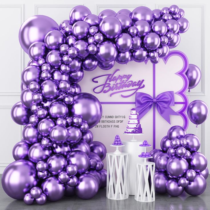 purple balloons are arranged in the shape of an arch