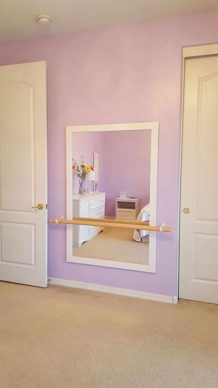 an empty room with purple walls and white doors