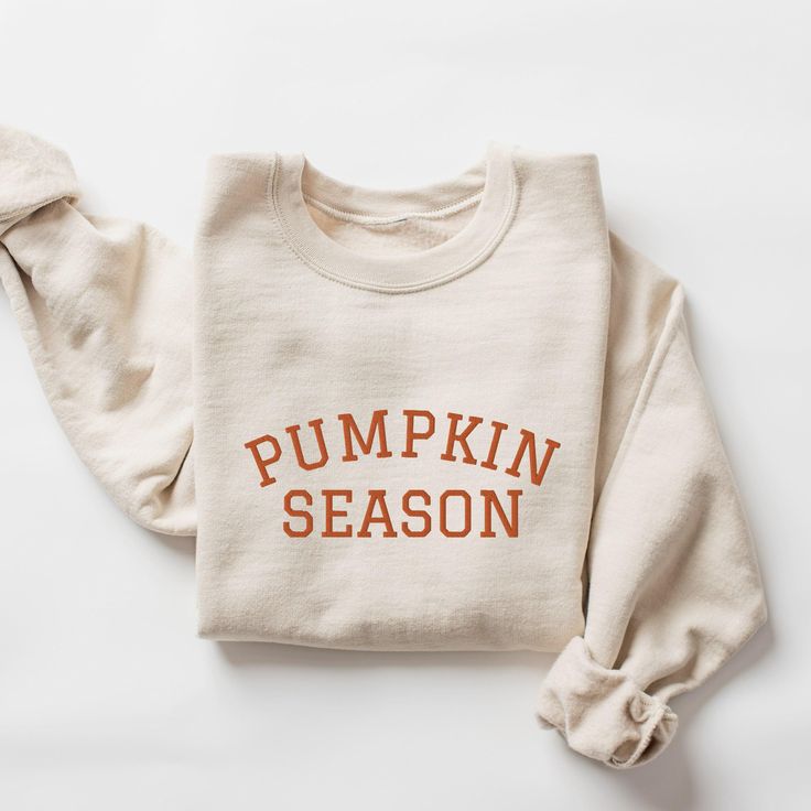 Embroidered Pumpkin Season Sweatshirt. Embroidered with orange thread. Each one is made under eco-friendly, sweatshop-free and ethical working conditions. A sturdy and warm sweatshirt bound to keep you warm in the colder months. A pre-shrunk, classic fit sweater that's made with air-jet spun yarn for a soft feel. This is a unisex sweatshirt, not fitted. Check the size chart for your perfect fit! This product is made especially for you as soon as you place an order, which is why it takes us a bit Fall Cotton Orange Sweater, Orange Cotton Sweatshirt With Relaxed Fit, Orange Relaxed Fit Cotton Sweatshirt, Orange Relaxed Fit Crew Neck Sweater, Orange Long Sleeve Cotton Sweater, Fall T-shirt With Embroidered Logo In Relaxed Fit, Fall Relaxed Fit T-shirt With Embroidered Logo, Relaxed Fit T-shirt With Embroidered Logo For Fall, Fall Cotton T-shirt With Embroidered Graphics