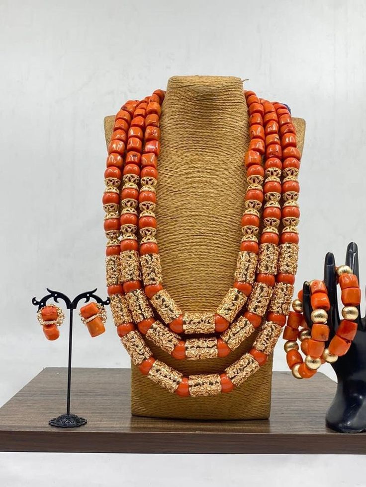 Handcrafted African Coral Beads Necklace - Unique Ethnic Jewelry for a Statement Look Materials: 1. Natural/Original African Coral bead 2. Gold color accessories  3. This listing contains 3 layers of necklace, 2 bracelets and a set of earrings. Length of Necklace: 16 - 20inches Colour of Accessories: Gold   Description: 🌍 African Elegance: Immerse yourself in the rich cultural tapestry of Africa with this exquisite necklace. Each vibrant coral bead tells a story of tradition, craftsmanship, and Bohemian Colorful Beads For Wedding, Bohemian Gold Bridal Necklace With Polished Beads, Handmade Jewelry For Traditional Ceremonies And Festivals, Red Handmade Jewelry For Wedding, Orange Gold Beaded Jewelry For Gift, Orange Hand-strung Jewelry With Round Beads, Hand-strung Orange Jewelry With Round Beads, Orange Jewelry With Gold Beads For Gift, Red Artisan Jewelry For Wedding