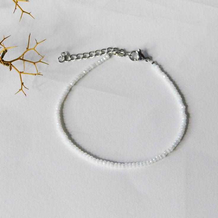 white crystal anklet, seed anklet, minimal white anklet. This beautiful handmade anklet made from 1mm white crystal beads. The anklet closes with a stainless steel clasp. This beautiful anklet is perfect for day or night outfit. SIZE Anklet is 10 inches (8 inches with 2 inches adjustable stainless steel chain) Please let me know if you would like a different length. All PolysJewelryArt jewelry arrived in a beautiful box or pouch ready for giving. We advise you to try to keep the jewelry away from water, chemicals and perfumes to keep it in perfect contition. Feel free to contact me for any questions or requests. CANCELLATIONS - We accept cancellations within 12 hours of purchase. Delicate White Anklet As A Gift, Dainty White Anklet Suitable For Gift, Dainty White Anklets Perfect For Gifts, Dainty White Anklets For Gift, Dainty White Anklets As Gift, Handmade Minimalist Crystal Bracelet, White Beaded Chain Bracelets, White Minimalist Crystal Bracelet For Everyday, Minimalist White Crystal Bracelet For Everyday