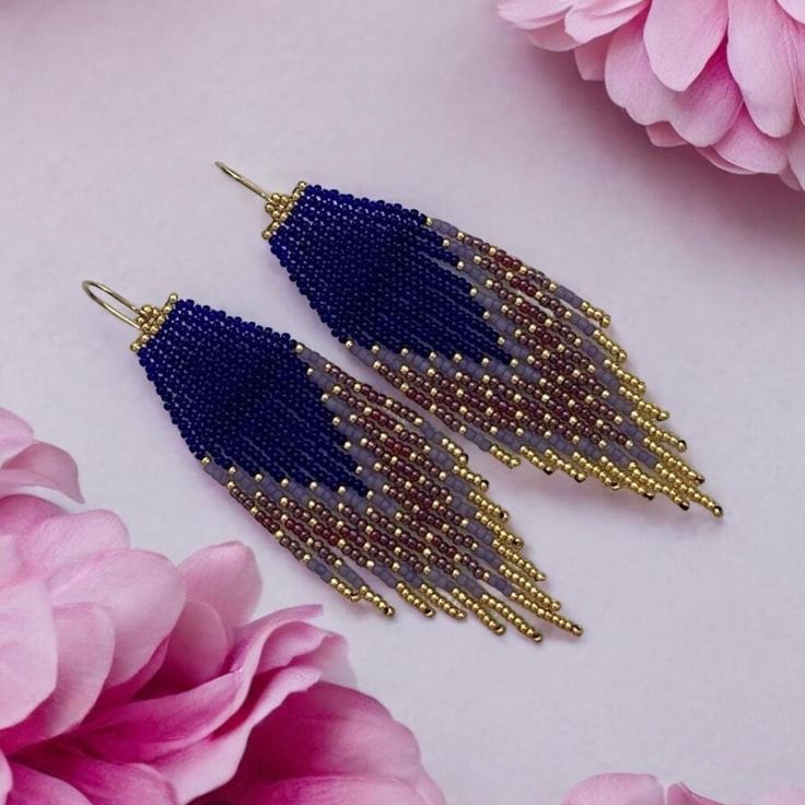 These Statement Boho Blue Gold Earrings are a stunning addition to any jewelry collection. Handcrafted with intricate beadwork, these earrings feature bold blue and gold hues that capture the essence of bohemian elegance. Perfect for making a fashion statement, these dangle earrings are both unique and versatile, ideal for casual and formal occasions. Whether you're dressing up for a special event or adding a touch of flair to your everyday look, these artisan earrings will make you stand out. T Blue Beaded Drop Earrings For Festival, Blue Bohemian Beaded Earrings For Pierced Ears, Blue Bohemian Earrings For Pierced Ears, Blue Bohemian Dangle Earrings, Blue Beaded Festival Earrings With Ear Wire, Artisan Dangle Earrings With Faceted Beads, Blue Beaded Earrings For Festival With Ear Wire, Bohemian Teardrop Blue Earrings, Bohemian Blue Long Drop Beaded Earrings