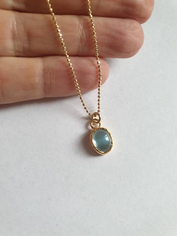 This minimalist Blue Topaz solid gold necklace was designed with a light blue December birthstone pendant, to beautifully accompany you through your busy days.The classic simple design is always pretty for day and evening, work or fun.The gold Blue Topaz necklace is handmade and delicate and available both with a 9kt or 14 karat pendant. The gold chain is made of 14k and available in a couple lengths.The clear Blue topaz necklace is a great birthstone necklace and a perfect chic and elegant gift Dainty Blue Topaz Necklace, Blue Birthstone Charm Necklace, Minimalist Gold Jewelry With Blue Topaz, Light Blue Birthstone Necklace For Anniversary, Gold Necklace With Blue Topaz Birthstone, Dainty Blue Charm Necklace For Everyday, Minimalist Gold Birthstone Necklace With Gemstone, Minimalist Birthstone Oval Pendant Necklace, Minimalist Birthstone Necklace With Oval Pendant