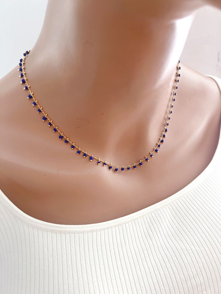 Dainty blue beaded dangle choker necklace -------------------- Details *14K gold plated cable chain *cable chain: 1.8x5.2mm  *Beads 2mm -------------------- Necklace Length ・This necklace is available in 4 sizes 12"-14" (12" + adjustable 2 - inch extender) 14"-16" (14" + adjustable 2 - inch extender) 16"-18" (16" + adjustable 2 - inch extender) 18"-20" (18" + adjustable 2 - inch extender)i ・It closes with lobster clasp.  -------------------- Jewelry care ・Plated brass items are expected to tarni Blue Beaded Necklaces With Delicate Chain And Round Beads, Blue Beaded Clavicle Chain Necklace As Gift, Blue Beaded Necklaces With Delicate Chain, Blue Beaded Clavicle Chain Necklace For Gift, Blue Necklaces With Clavicle Chain And Round Beads, Blue Clavicle Chain Necklaces With Round Beads, Party Jewelry With Tiny Blue Beads, Blue Beaded Chain Necklace As Gift, Dainty Blue Beaded Necklaces With Delicate Chain