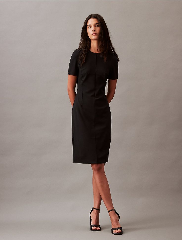 Cut from smooth stretch crepe, this dress has a slim, fitted silhouette. Defined with seaming accents and styled with a single vent. Detailed with a zip closure along the back.  Material: 95% Polyester, 5% Elastane. Dresses Calvin Klein, Shift Dress Black, Stretch Crepe, Calvin Klein Woman, Fitted Silhouette, Work Attire, Split Hem, Dress Clothes For Women, Shift Dress