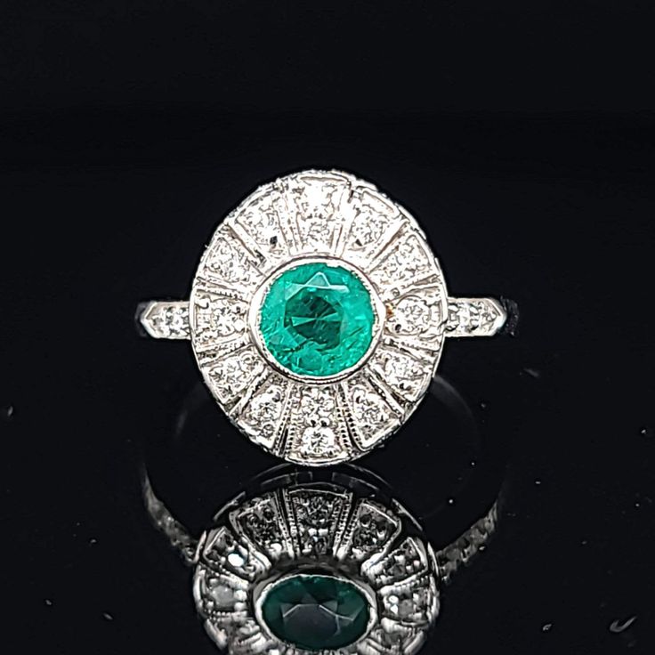 Vintage natural emerald in 14k white gold ring circ 1940's center natural green emerald in round shape weight 0.92ct SIZE 5.8mm side set natural diamonds weight 0.50ct H-SI1 lively,sparkly stone.clean. Ring size 6.5 This tremendous old vintage ring is in a very good condition. Appraisal available Retail value $4,750 net Vintage Green Diamond Ring In Platinum, Vintage Green Diamond Platinum Ring, Art Deco Emerald Ring In Platinum, Art Deco Platinum Emerald Ring, Green Platinum Halo Ring, Art Deco Round Emerald Ring With Center Stone, Gia Certified 14k White Gold Emerald Ring, Platinum Emerald Ring With Center Stone, Platinum Emerald Ring With Hallmark