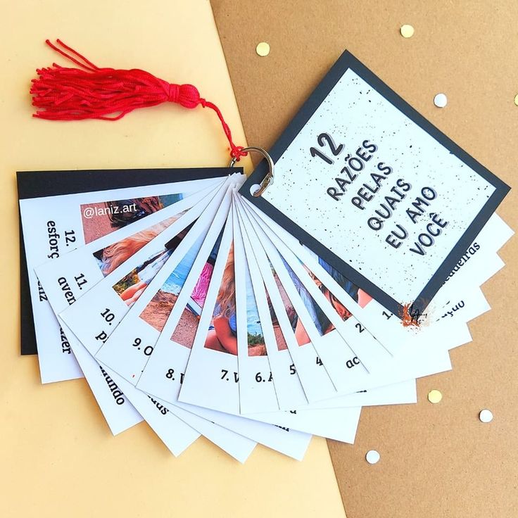 a bunch of cards that are on top of a table next to a red tassel