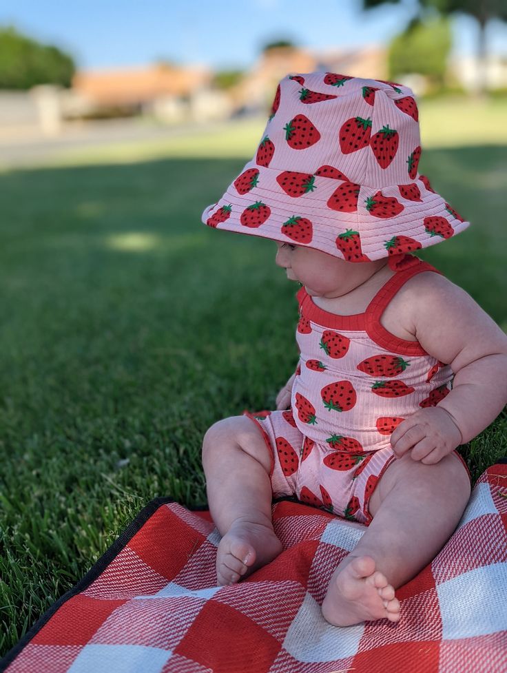 The CUTEST summer matching set that will get you so many compliments. Made from the softest rib knit in a trendy strawberry print is bound to be you and your little one's favorite outfit.  Please be sure to measure your child for the correct fit. If you order a set and need different sizes, just add a note at checkout!  The cami has contrast color straps and a lettuce edge hem (can request regular hem) The bike shorts have a contrast yoga style waistband, and is finished with a lettuce edge hem (can request elastic waist or regular hem) The bucket hat is completely REVERSIBLE!  Want this is another print or color? Want something completely different? I take custom orders, just message me! Fun Baby Clothes, Strawberry Baby Outfit, Cute Fitted Diaper Cover For Playwear, Cute Summer Hats For Playtime, Fun Summer Playwear For Babies, Playful Summer Diaper Cover For Playwear, Playful Diaper Cover For Summer Playwear, Playful White Diaper Cover For Summer, Cute Summer Sun Hat For Playtime