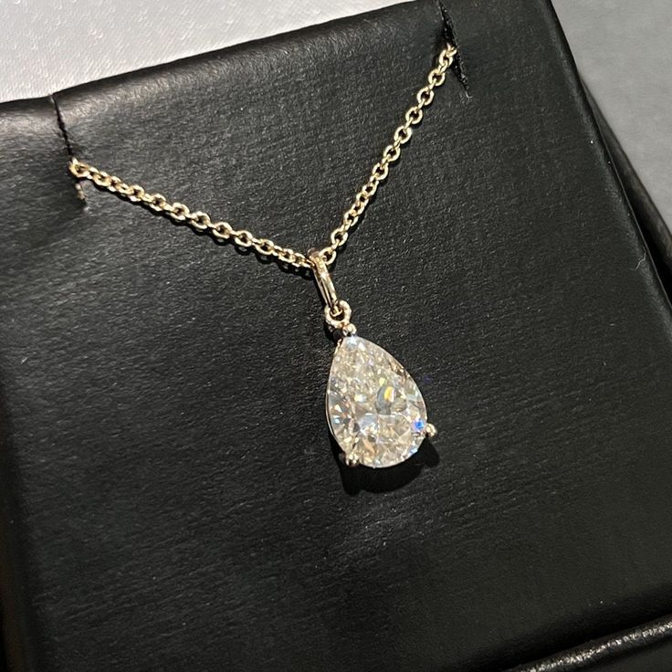 Moissanite offers timeless beauty and exceptional value. This beautiful pendant and chain set features a GRA certified VVS1 clarity D color Moissanite hand set by our master jewelers on a durable 14K gold setting. This is the best compromise between cheap fakes (CZ, crystal, rhinestone) and an extremely expensive diamond. Natural diamond equivalent stones cost $10,000 - $100,000+. Get the same look at a reasonable price. Necklace can be worn at 16, 17, and 18 inch lengths. Order yours today! -Be Luxury Pear-shaped Necklace With Halo Setting, Timeless Pear-shaped Diamond White Jewelry, Wedding Diamond Necklace With Vvs Clarity Teardrop Pendant, Timeless Pear-shaped Jewelry With Vvs Clarity, Dazzling Pear-shaped Jewelry For Gift, Elegant Pear-shaped Cubic Zirconia Solitaire Necklace, Elegant Pear-shaped Solitaire Necklace For Anniversary, Lab Grown Diamond Teardrop Jewelry In Prong Setting, Teardrop Lab Grown Diamond Jewelry With Vvs Clarity