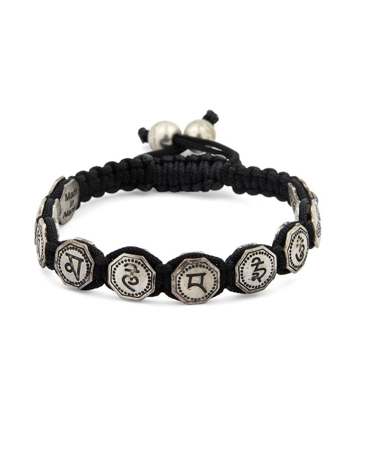 This symbolic Tibetan bracelet features the Om Mani Padme Hum – the most frequently used mantra in Buddhism. It represents teaching, wisdom, and the union of learning and enlightenment. On the reverse of each disk, you'll notice the double vajra, a spiritual tool associated with compassion and protection throughout the universe. Tibetan symbols bracelet Base metal beads with mantra and vajra symbols Colored accent beads Adjustable pull cord fits most wrists Handmade in Nepal Rustic in finish, no Tibetan Symbols, Tibetan Mantra, Buddha Groove, Buddhist Bracelet, Tibetan Bracelet, Buddha Jewelry, Om Mani Padme Hum, Spiritual Tools, Meaningful Jewelry