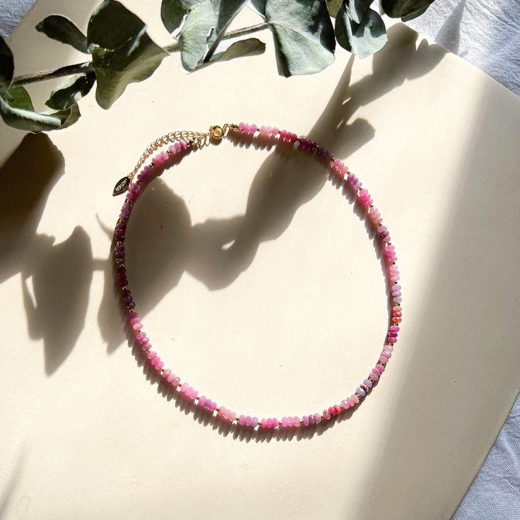 Dainty faceted Ruby beads strung with tiny gold spacers. Glowing with energy, these pink and red hued precious stones are a heart lifter. It is one of the four traditional main gemstones worn by nobility through the ages. Its power in history is unmatched. In Middle Ages Europe, wearing Rubies was believed to bring good health to the wearer. In Burma, where the stone is famously found, they went further and put them underneath the skin for protection. Mongol Emperor Kublai Khan is said to have t Pink Spiritual Necklace With Faceted Beads, Pink Spiritual Crystal Necklaces With Faceted Beads, Pink Spiritual Jewelry With Faceted Beads, Spiritual Pink Jewelry With Faceted Beads, Gift Single Strand Rondelle Beaded Necklace, Pink Jewelry With Faceted Round Beads, Pink Spiritual Beaded Necklace With Gemstone Beads, Pink Rondelle Beaded Necklace As Gift, Pink Single Strand Crystal Necklace Gift